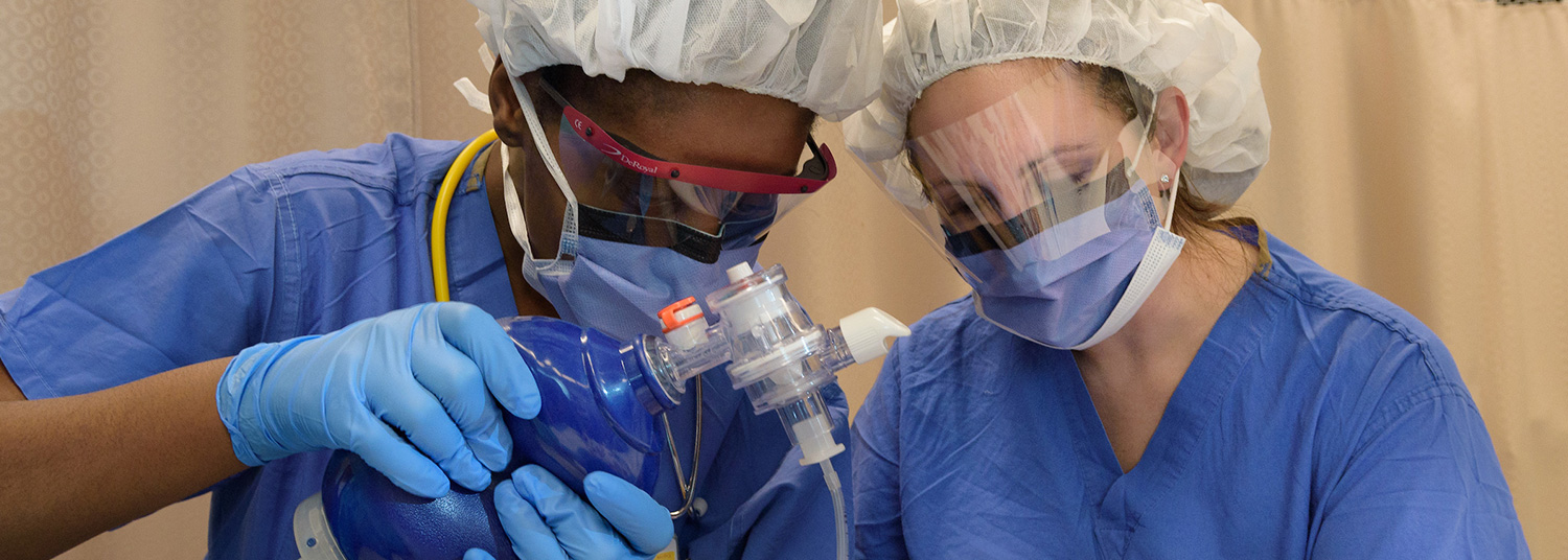 Anesthesiologists intubating patient