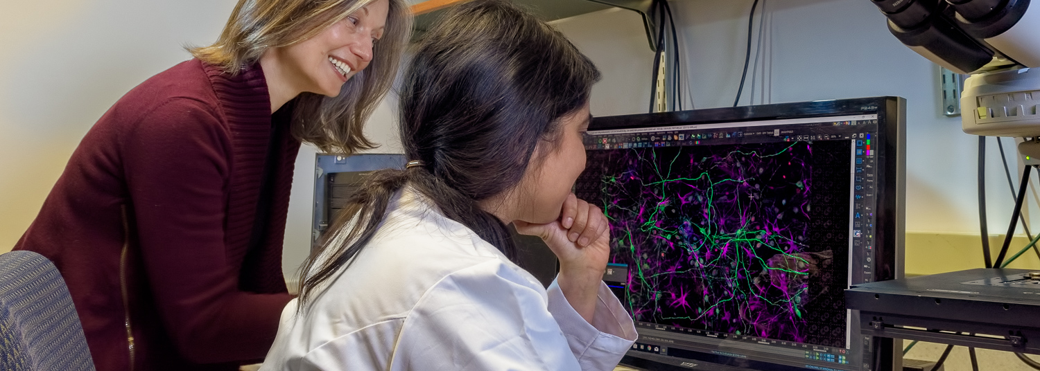 Dr. Lapinski helping student in lab