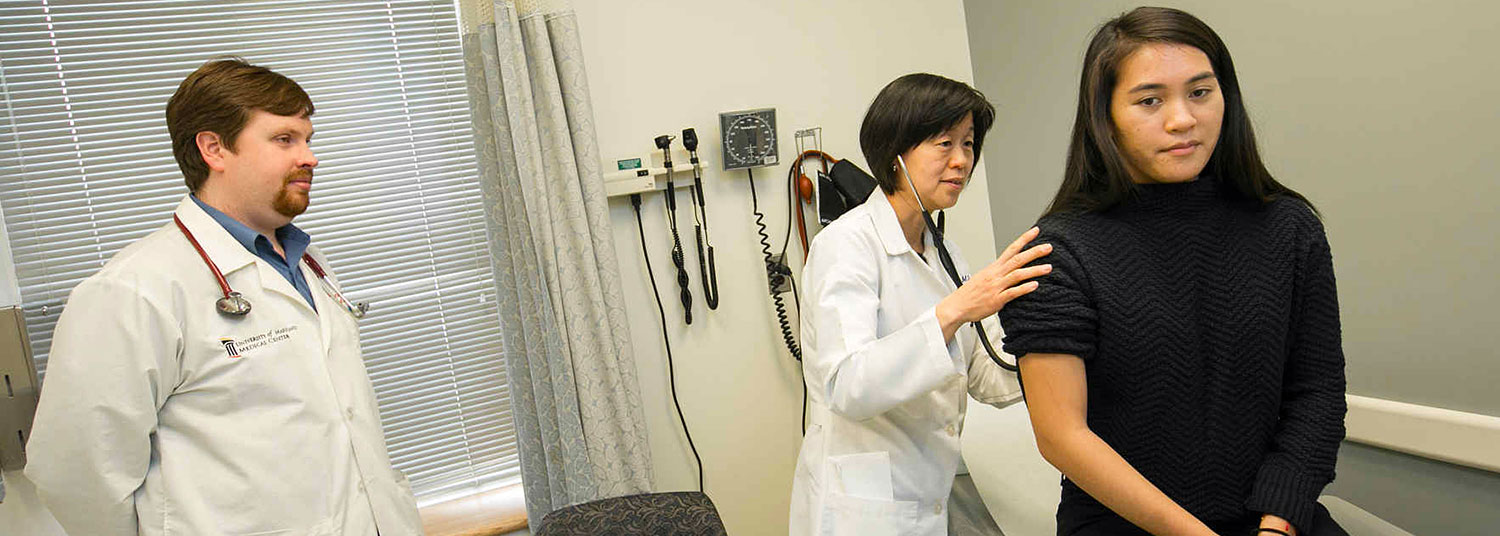 two doctors examine a patient in a doctor's office