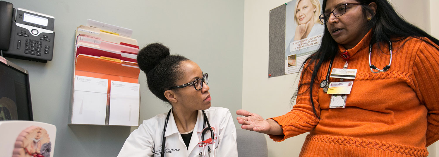 Two faculty members have a discussion