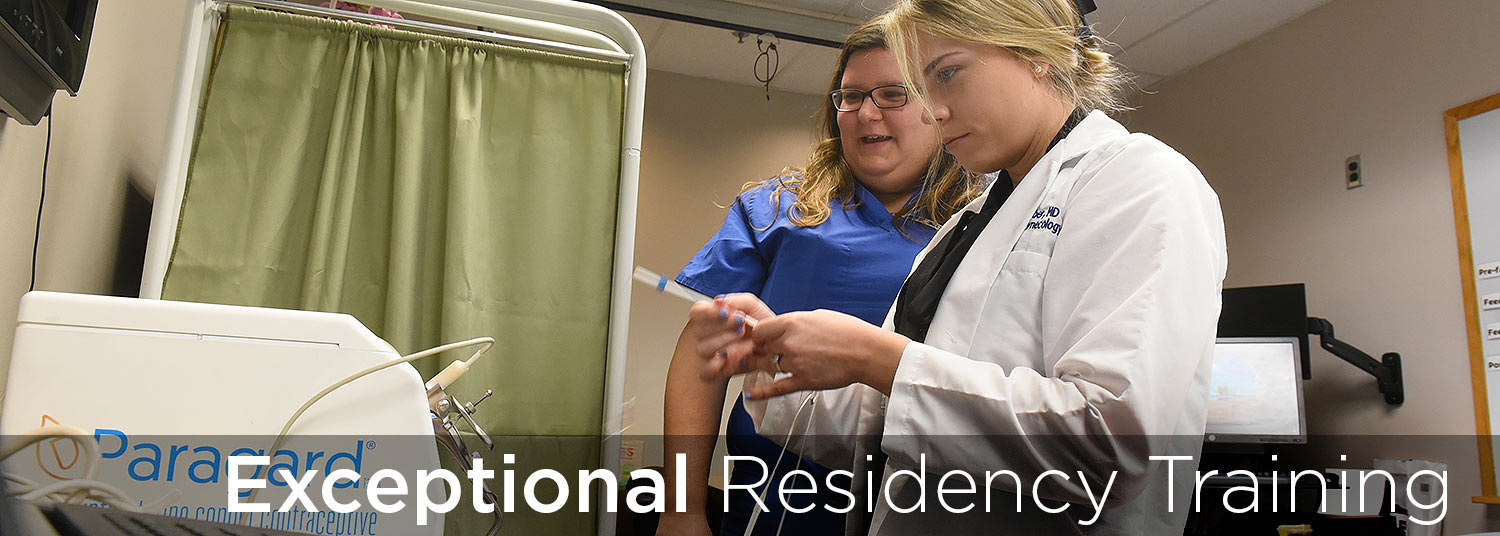 Physician and resident caring for patient