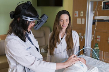 Physicians examining newborn