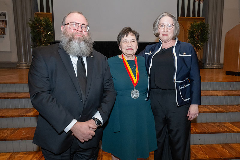 Three people at ceremony